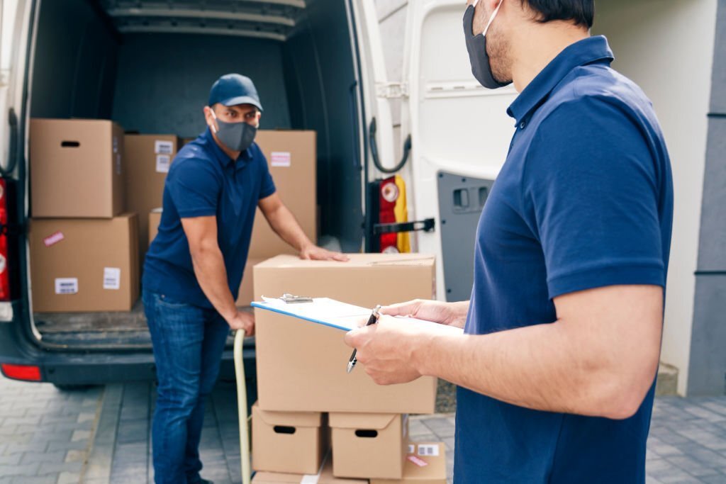 Couriers in a protective face mask while working